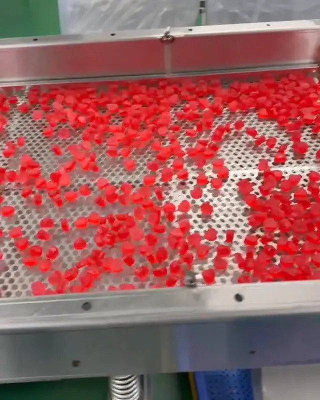 Red gummies on a sorting screen